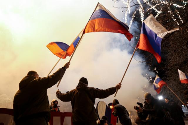 친러시아 분리주의 지지자들이 21일 우크라이나 동부 도네츠크에서 러시아 국기를 흔들며 분리독립 승인을 축하하고 있다. 도네츠크=AP 연합뉴스