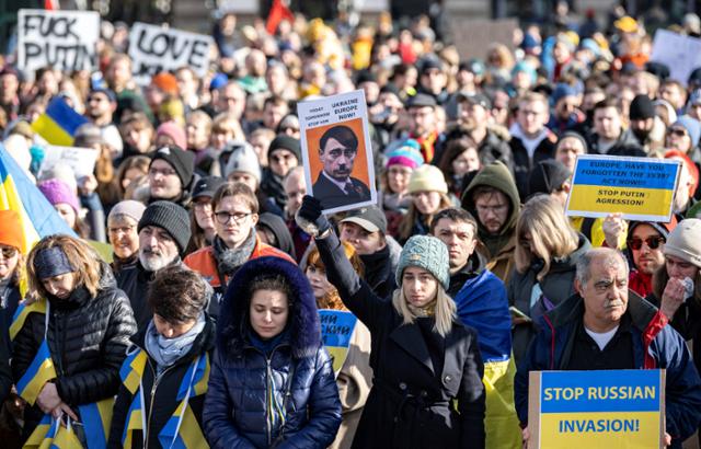 러시아를 규탄하고 우크라이나를 지지하는 스웨덴 국민들이 지난달 27일 말뫼 묄레봉 광장에서 집회를 열고 있다. 블라디미르 푸틴 대통령을 히틀러에 빗댄 사진도 보인다. 말뫼=로이터 연합뉴스