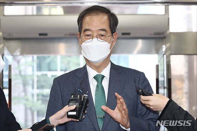 [서울=뉴시스] 배훈식 기자 = 한덕수 국무총리 후보자가 4일 오전 서울 종로구 한국생산성본부 빌딩에 마련된 청문회 준비단 사무실로 첫 출근하며 취재진의 질문에 답하고 있다. (공동취재사진) 2022.04.04. photo@newsis.com