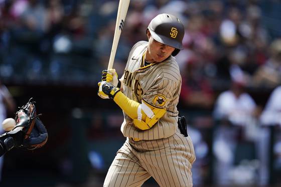 San Diego Padres' Kim Ha-seong gets hit by a pitch during a game against the Arizona Diamondbacks on Sunday in Phoenix, Arizona. [AP/YONHAP]
