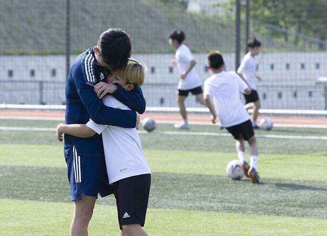 손흥윤 코치는 훈련을 엄하게 하지만 쉴 때는 아이들을 안아줬다. 김현동 기자