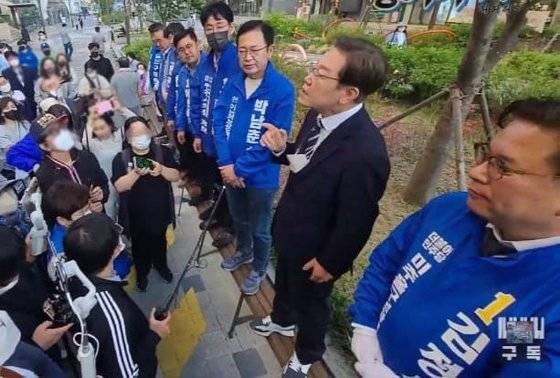 이재명 더불어민주당 선거대책위원장이  15 일 인천 거리 유세 도중 벤치에 신발을 신고 올라간 모습 . [ 이준석 국민의힘 대표 페이스북 캡처 ]