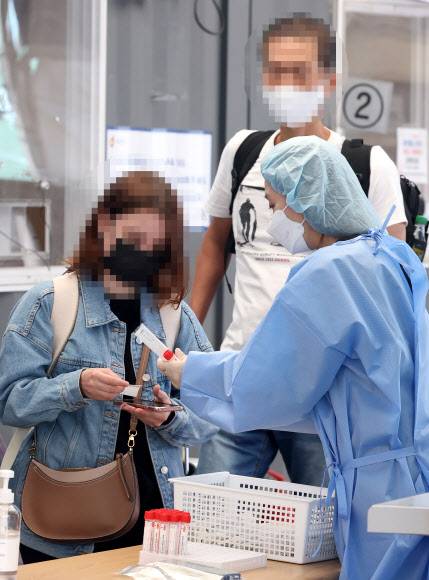 코로나19 신규 확진 감소세 뚜렷 - 코로나19 신규 확진이 104일 만에 1만 명대를 기록한 16일 오전 서울 중구 서울역 코로나19 선별검사소에서 해외입국자가 PCR 검사를 받기 위해 안내를 받고 있다.      중앙방역대책본부는 이날 0시 기준으로 신규 확진자가 1만3천296명 늘어 누적 1천779만5천357명으로 집계됐다고 밝혔다.      신규 확진자 수는 전날(2만5천434명)보다 1만2천138명 적다. 보통 월요일 발표되는 신규 확진자 수는 휴일인 주말 검사 건수가 감소하는 영향으로 주중 가장 적게 나오는 경향이 있다. 2022.5.16 연합뉴스