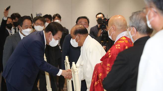 윤석열 대통령이 28일 용산 청사 접견실에서 열린 7대 종교지도자 오찬 간담회에서 참석자들과 인사를 나누고 있다. /뉴스1