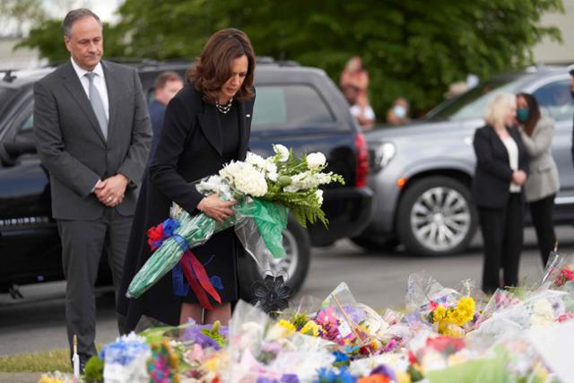카멀라 해리스(앞줄 오른쪽) 미국 부통령이 남편 더글러스 엠호프와 함께 28일 미국 뉴욕주 버펄로에서 열린 총기 난사 희생자의 장례식에 참석해 꽃을 바치고 있다. 버펄로=AFP 연합뉴스