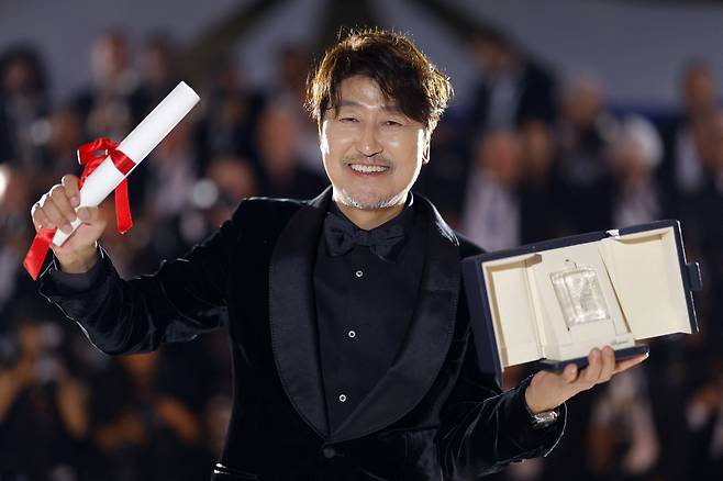 Actor Song Kang-ho of “Broker” poses for photos after winning the best actor award at the 75th Cannes Film Festival in Cannes, France, on Saturday. (Reuters-Yonhap)
