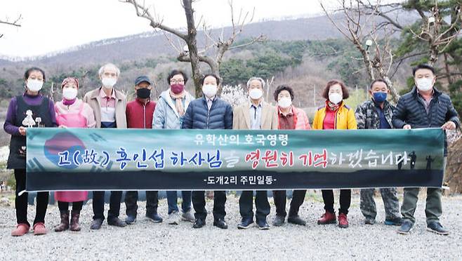 칠곡군 석적읍 도개2리 주민들이 마을을 지키다 전사한 고(故) 홍인섭 하사를 추모하는 현수막을 들고 있다. 칠곡군 제공