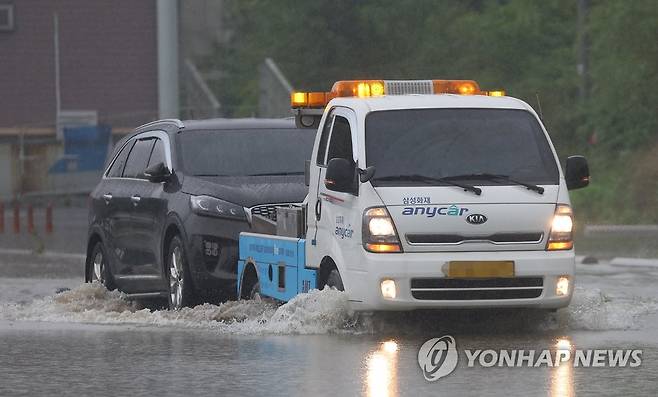 물에 잠긴 주차장에서 탈출 (서울=연합뉴스) 김도훈 기자 = 팔당댐 일부 수문이 개방된 30일 물에 잠긴 서울 반포한강공원 주차장에서 견인차가 주차된 차량을 옮기고 있다. 2022.6.30 superdoo82@yna.co.kr