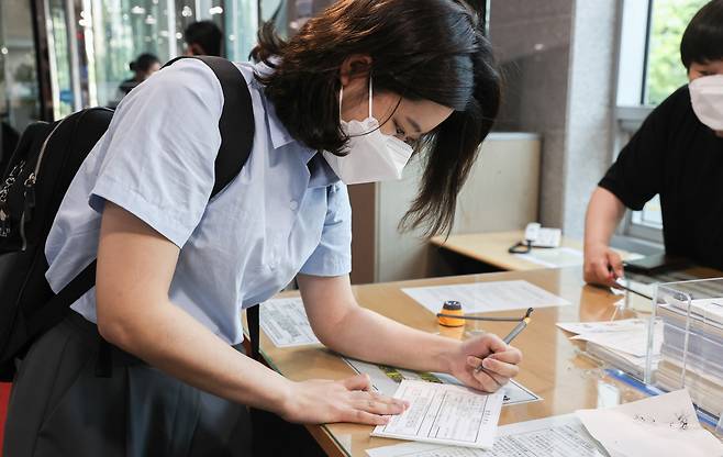 박지현 전 더불어민주당 비상대책위원장이 1일 서울 여의도 국회 의원회관에서 열린 그린벨트 결과 공유 파티 '용감한 여정'에 참석하기 위해 방문 신청서를 작성하고 있다. [연합]