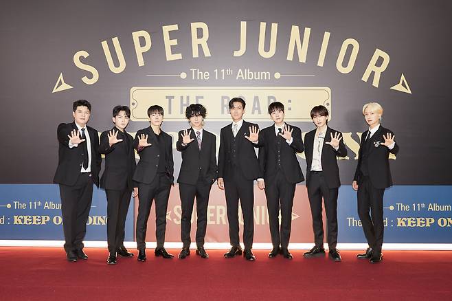 Members of Super Junior pose for photos during an online press conference for the group’s 11th full-length album “Vol.1 ‘The Road: Keep on Going’” on Tuesday. (Label SJ)