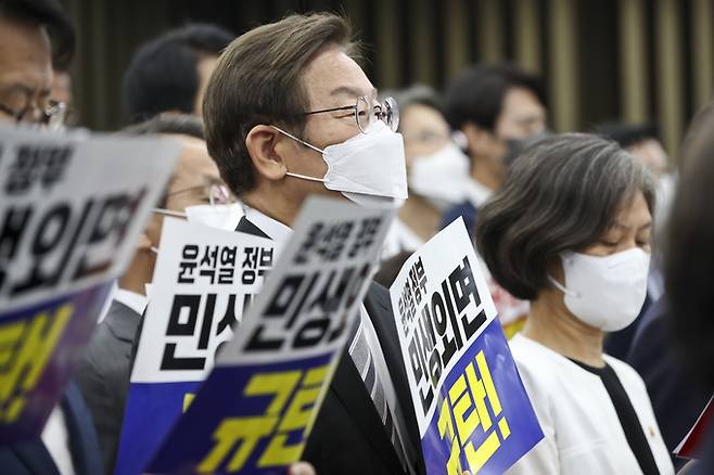 더불어민주당 이재명 의원이 지난 11일 오후 국회에서 열린 의원총회에서 동료 의원들과 함께 윤석열 정부를 규탄하는 피켓을 들고 있다.    국회사진기자단