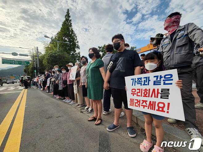 지난 14일 오후 경남 거제 대우조선해양 앞 도로에서 회사 임직원 및 가족, 거제시민, 상인 등이 거제통영고성조선하청지회의 불법 파업 중단을 촉구하는 '인간 띠 잇기' 행사를 진행하고 있다.(대우조선 제공).2022.7.14/뉴스1 © News1