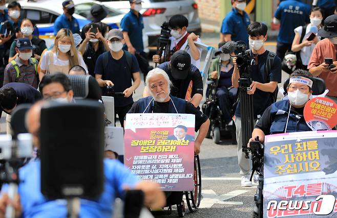 박경석 전국장애인차별철폐연대(전장연) 대표와 회원들이 19일 오전 서울 용산경찰서에 출석하고 있다. 이날 전장연은 장애인 이동권 보장을 요구하며 출퇴근길 지하철 시위를 한 것과 관련해 조사를 받기 위해 용산경찰서에 출석했다가 청사에 장애인 등 교통약자를 위한 승강기가 설치되지 않았다며 조사를 거부하고 돌아갔다. 2022.7.19/뉴스1 © News1 구윤성 기자