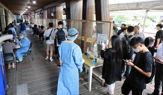코로나 신규확진자가 7만 명을 넘은 19일 오전 서울 송파구 보건소 선별진료소에서 시민들이 검사를 기다리고 있다.                                                                                          사진=연합뉴스
