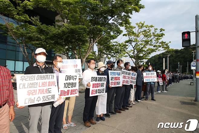 14일 오후 경남 거제 대우조선해양 앞 도로에서 회사 임직원 및 가족, 거제시민, 상인 등이 거제통영고성조선하청지회의 불법 파업 중단을 촉구하는 '인간 띠 잇기' 행사를 진행하고 있다.(대우조선 제공).2022.7.14/뉴스1 © News1 강대한 기자