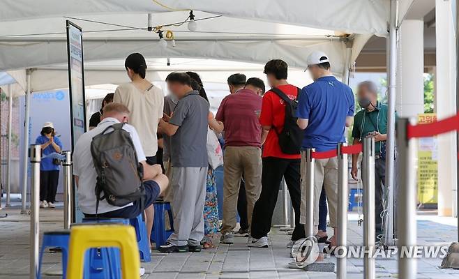 코로나19 전자문진표 작성하는 시민들 (서울=연합뉴스) 김인철 기자 = 코로나19 신규확진자가 9만9327명으로 다시 10만명에 근접한 26일 오전 서울 마포구보건소 코로나19 선별진료소에서 검사를 받으려는 시민들이 전자문진표를 작성하고 있다. 2022.7.26 yatoya@yna.co.kr