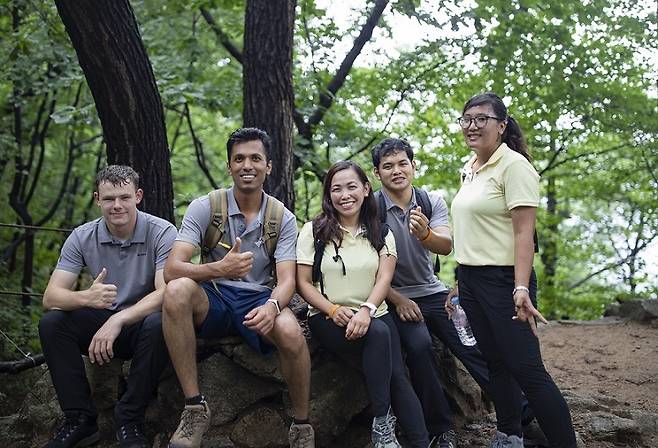 A group of foreign hikers decked out in rented hiking outfits pose for a photo on a trail in Bukhansan National Park. (Seoul Tourism Organization)