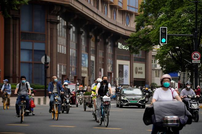 중국 상하이 시민들이 시내 도로에서 자전거와 오토바이를 타고 이동하고 있다. /로이터 뉴스1