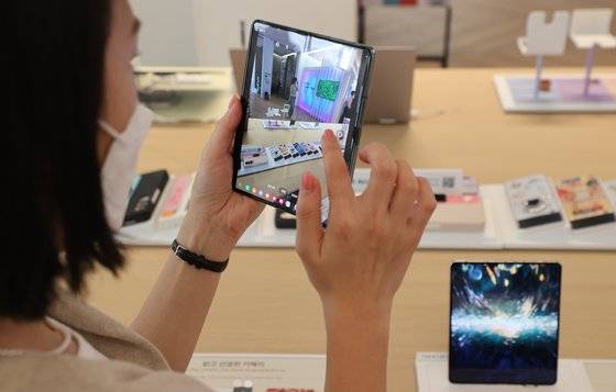 지난 11일 서울 강남구 삼성디지털플라자 강남본점에서 방문객들이 스마트폰 갤럭시Z플립4와 갤럭시Z폴드4 제품을 살펴보고 있다. 연합뉴스