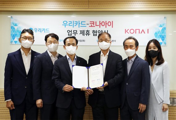 김정기 우리카드 사장(왼쪽 세번째)과 조정일 코나아이 대표(왼쪽 네번째)를 포함한 양사 관계자들이 업무협약을 체결한 뒤 기념촬영을 하고 있다.