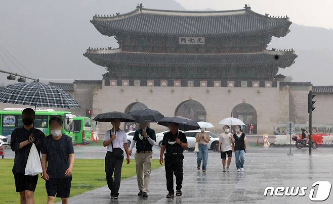 소나기가 내린 지난 6일 서울 종로구 광화문 앞 삼거리도로에서 우산을 쓴 시민들이 발걸음을 옮기고 있다. /사진=뉴스1