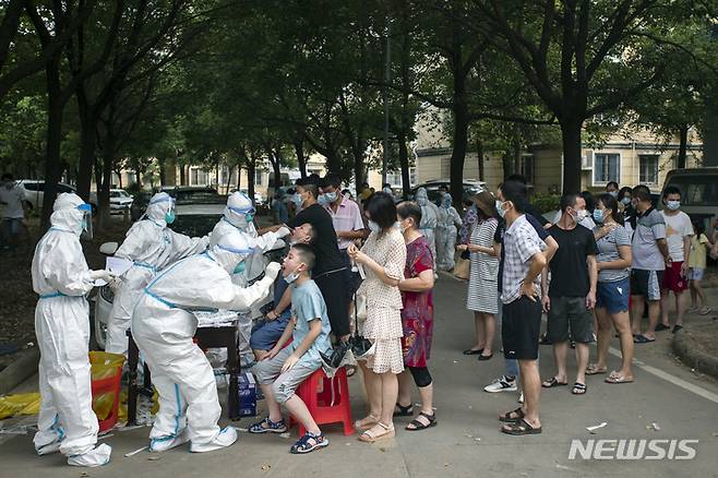 [우한(중국 후베이성)=AP/뉴시스]지난 2021년 8월3일 중국 후베이(湖北)성 우한(武漢)에서 시민들이 길게 줄을 서 코로나19 진단 검사를 받고 있다. 코로나19가 처음 발생했던 우한의 장샤(江夏)구에서 무증상 감염자 4명이 새로 발생, 거의 100만명에 달하는 시민들이 봉쇄됐다. 이들에게는 3일 간 집이나 아파트 밖으로의 외출이 전면 금지됐다. 2022.7.28