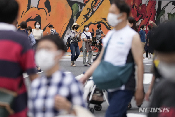 지난 12일 마스크를 착용한 시민들이 도쿄의 한 횡단보도를 건너고 있다. AP/뉴시스