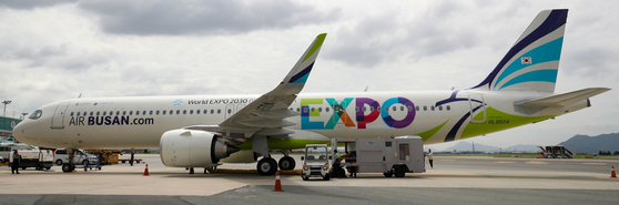 An Air Busan plane at the Gimhae International Airport in Busan Thursday is decorated to promote the city's bid to host the World Expo 2030. [NEWS1]