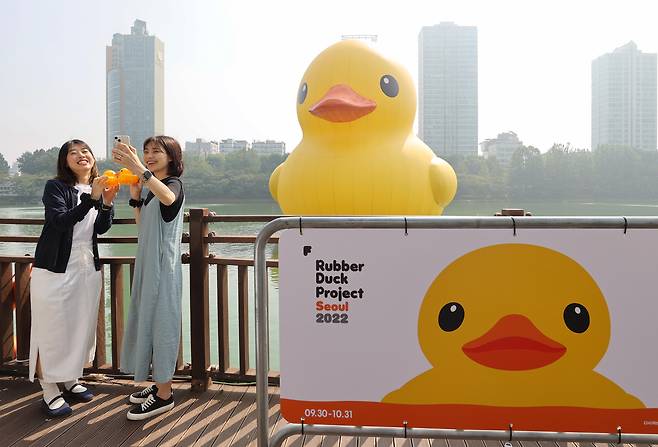 <YONHAP PHOTO-3477> '러버덕과 함께'     (서울=연합뉴스) 이재희 기자 = 29일 오전 서울 송파구 석촌호수 동호에 설치된 러버덕 앞에서 전시 관계자들이 기념촬영을 하고 있다. 2014년 이후 8년 만에 다시 돌아온 러버덕은 플로렌타인 호프만 작가가 제작한 작품으로 10월 31일까지 전시된다. 2022.9.29     scape@yna.co.kr/2022-09-29 13:49:27/ <저작권자 ⓒ 1980-2022 ㈜연합뉴스. 무단 전재 재배포 금지.>
