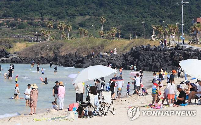 늦더위 제주 해수욕장 북적거려 (제주=연합뉴스) 전지혜 기자 = 개천절인 3일 제주의 낮 기온이 30도 안팎을 보여 무더운 가운데 제주시 조천읍 함덕해수욕장에서 나들이객들이 바닷물에 다리를 담그거나 바닷가에 앉아 더위를 식히고 있다. 2022.10.3 atoz@yna.co.kr