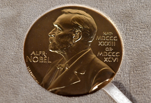 ▲ FILE - A Tuesday, Dec. 8, 2020 file photo of a Nobel medal displayed during a ceremony in New York. (Angela Weiss/Pool Photo via AP, File) FILE PHOTO