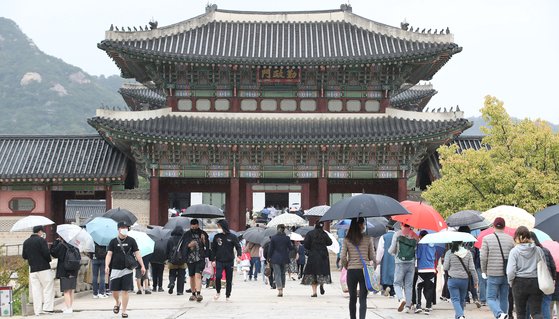 한글날인 9일 오전 전국 대부분 지역 비가 내리는 가운데 서울 종로구 경복궁을 찾은 시민들이 우산을 쓰고 발걸음을 옮기고 있다. 뉴스1