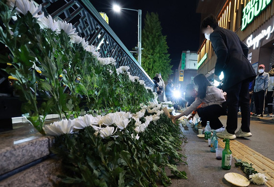 30일 오후 서울 용산구 지하철 6호선 이태원역 1번 출구 앞에 마련된 '핼러윈 인파' 압사 사고 희생자 추모 공간에서 시민들이 헌화하고 있다. 〈사진-연합뉴스〉