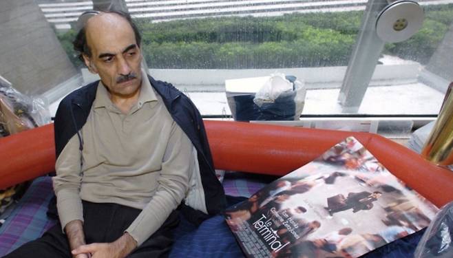 2004년 카리미 나세리가 공항에서 영화 ‘터미널’ 포스터를 가지고 있는 모습. [AFP/연합]