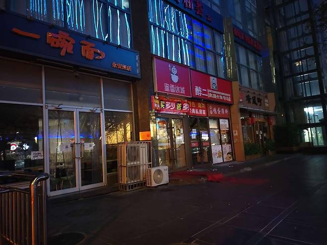 19일 오후 코로나가 급속도로 퍼지고 있는 중국 베이징시 차오양구의 가게들이 식당 내 취식 금지 등 방역 지침에 따라 문을 닫았다. /연합뉴스