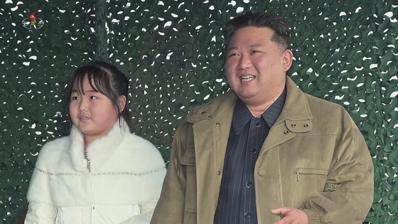 North Korean leader Kim Jong-un, right, and his daughter watch the launch of a new Hwasong-17 intercontinental ballistic missile (ICBM) at Pyongyang International Airport Friday in an image released by the North Korean Central Television Sunday. [YONHAP]