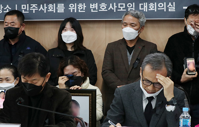 이태원 참사 유가족들이 22일 오전 서울 서초구 민주사회를 위한 변호사모임(민변)에서 열린 입장발표 기자회견에서 희생자들의 사진을 들고 눈물을 흘리고 있다.연합뉴스