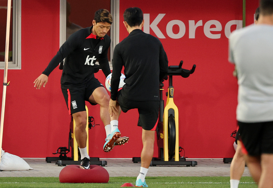 Hwang Hee-chan, left, trains on the field with Hwang In-beom during a training session at Al Egla Training Site in Doha, Qatar on Saturday. Hwang Hee-chan had noticeably skipped field training on Tuesday, just two days before kick off, suggesting that what has been reported as hamstring discomfort may well be serious enough to prevent him from playing.  [NEWS1]