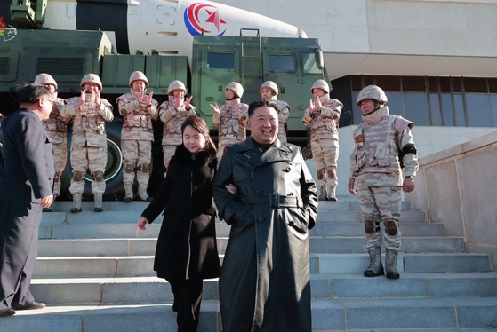 In a photo released Sunday by Pyongyang’s Korean Central News Agency, North Korean leader Kim Jong-un walks with his daughter during a commemorative photo session celebrating the North’s successful launch of a Hwasong-17 intercontinental ballistic missile (ICBM). [YONHAP]