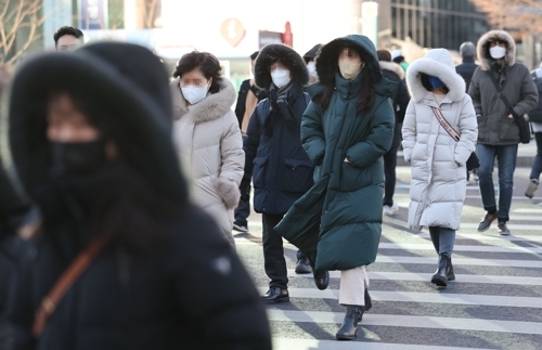 서울 광화문광장에서 시민들이 두꺼운 외투를 입고 걸어가고 있다. [사진 출처 = 연합뉴스]