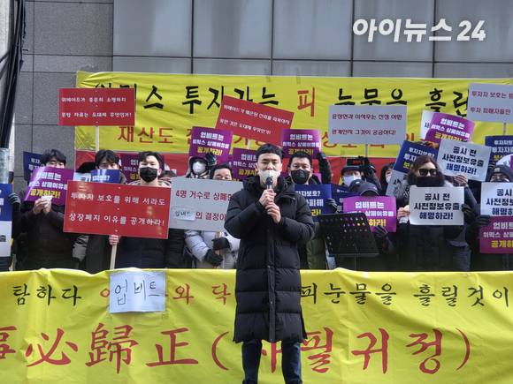 2일 오후 피켓을 든 위믹스 투자자들 앞 한 남성이 닥사 측에 항의하고 있다. [사진=박예진 기자]