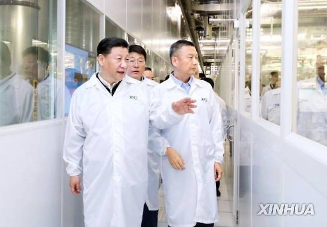 지난 2018년 4월 중국 우한에 있는 YMTC 공장에서 시진핑(왼쪽) 국가 주석이 자오웨이궈(가운데) 칭화유니그룹 회장 등이 반도체 생산 라인을 둘러보고 있다. [신화통신]