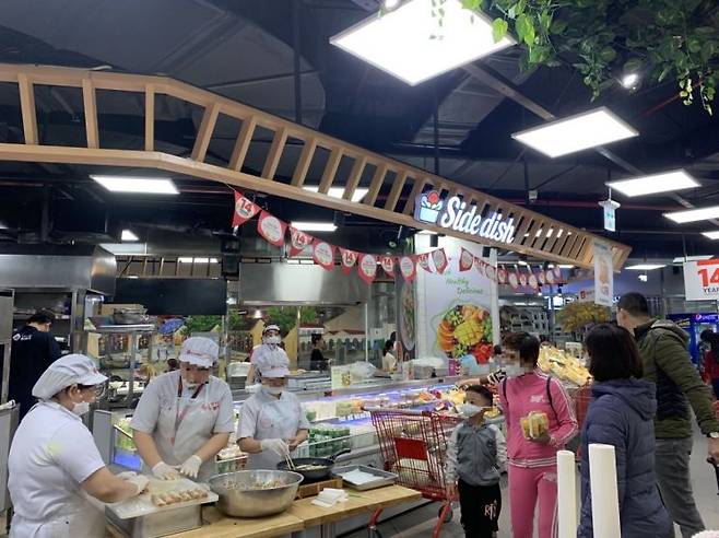 베트남 하노이 '롯데센터 하노이' 내 롯데마트 '사이드 디시' 코너에서 직원들이 즉석에서 요리를 하고 있다.