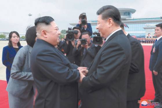 지난 6월 방북 일정을 마친 후 돌아가기 전 김정은 북한 국무위원장과 손을 잡고 인사 나누는 시진핑 중국 국가주석. 연합뉴스