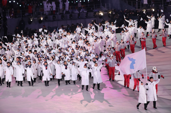 Athletes from North and South Korea enter together under the Korean Unification Flag at the opening ceremony of the 2018 PyeongChang Winter Olympics — the last Olympic games in which the North participated. [YONHAP]