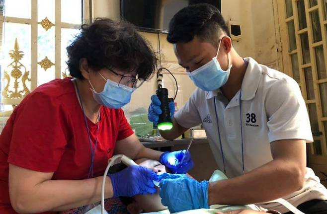 치과 진료를 하고 있는 정효경 대표(왼쪽) . 캄보디아의 친구들 제공
