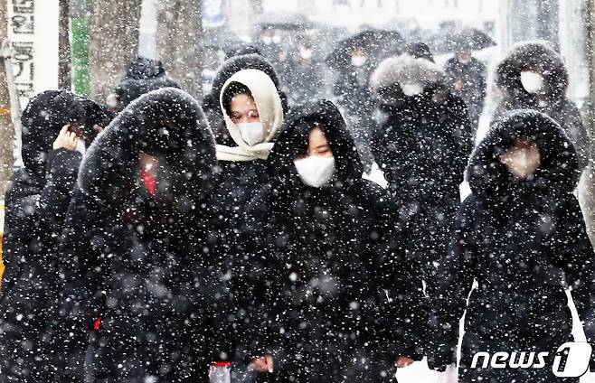 서울, 경기 등 수도권 전역과 중부 지방 곳곳에 대설주의보가 내려진 15일 서울 서초구 법원 삼거리에서 시민들이 내리는 눈을 피하기 위해 걸음을 재촉하고 있다. 2022.12.15/뉴스1 ⓒ News1 송원영 기자