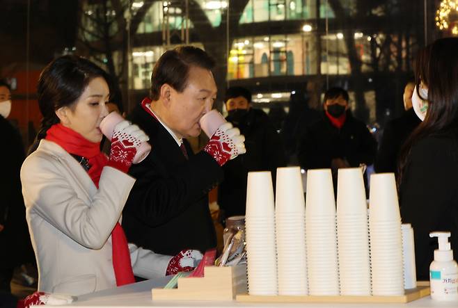 윤석열 대통령과 김건희 여사가 16일 오후 서울 종로구 열린송현광장에서 열린 윈·윈터 페스티벌 개막식에서 에어돔 부스를 방문, 음료를 마시고 있다. [사진출처 = 연합뉴스]