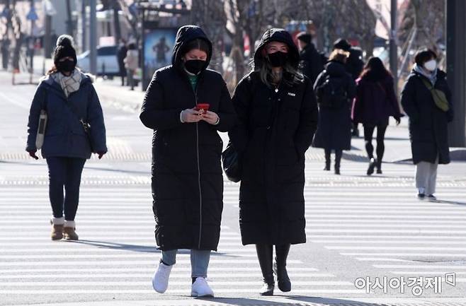 올겨울 최강 한파가 몰아친 18일 서울 광화문광장에서 외국인 관광객들이 두터운 옷차림을 하고 있다./김현민 기자 kimhyun81@