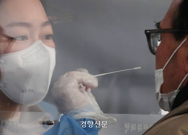 한 시민이 서울역 임시선별검사소에 검체를 채취하고 있다.  강윤중 기자